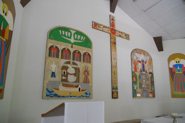 The artwork in the UCA chapel combines typical Catholic church embellishments with the reality of the Salvadoran situation. (ERIKA ALVERO KOSKI/The Stanford Daily))