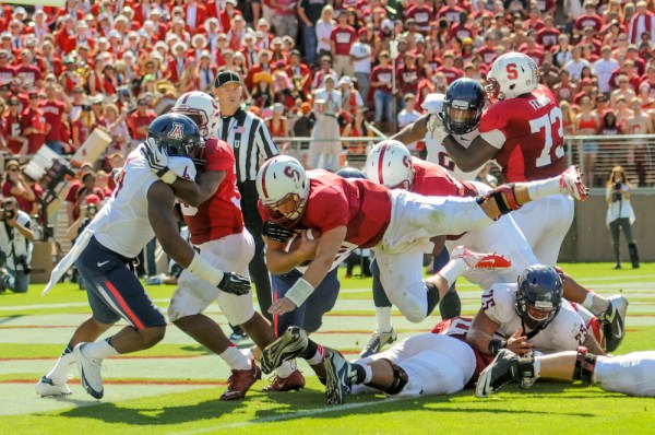 Quarterback Josh Nunes (above with ball) played the game of his life, rushing for three touchdowns and throwing for two more in the Cardinal's 54-48 overtime win over Arizona (SIMON WARBY/The Stanford Daily).