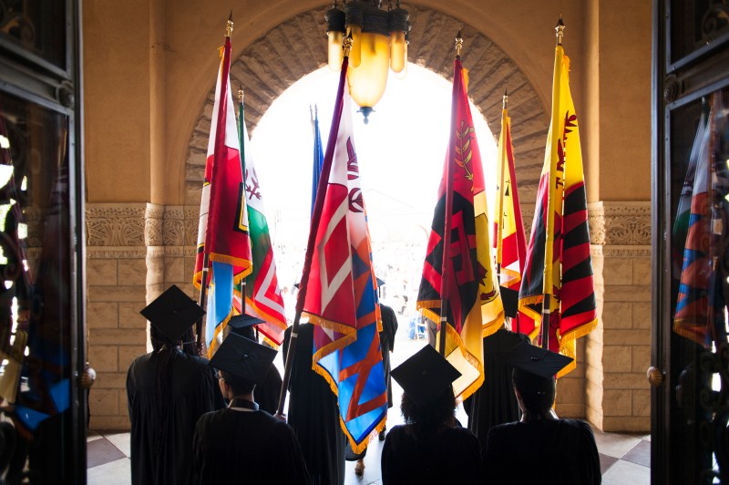 Flagbearers prepare to lead the procession before commencement.