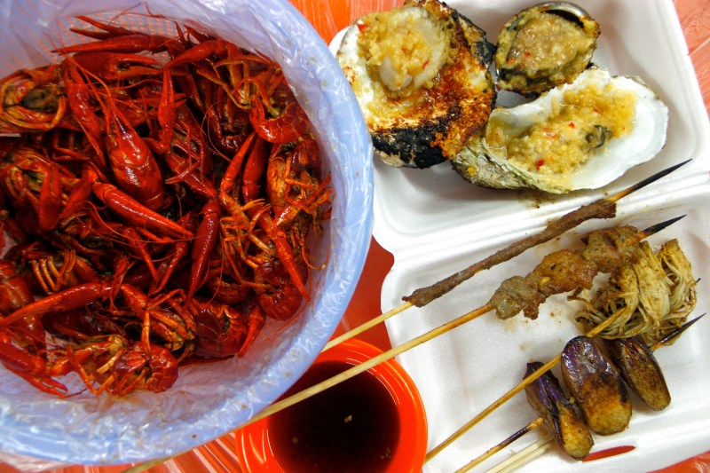 Although not pig intestines, these boiled crawfish, garlic grilled shellfish and grilled skewers at Shouning Road in Shanghai, China might not seem appealing to the casual eater. (Courtesy of Renjie Wong)