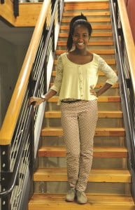 Fashion on the Farm columnist Keya Teklu poses in her Miley-inspired outfit, complete  with yellow knit sweater and plaid pants. (The Stanford Daily/Zetong Li)