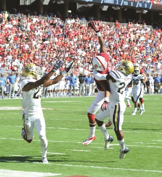 Sophomore wide receiver Kodi Whitfield (middle) made an eye-popping one-handed grab in traffic against UCLA Saturday, putting the Card up for good. (MIKE KHEIR/The Stanford Daily)