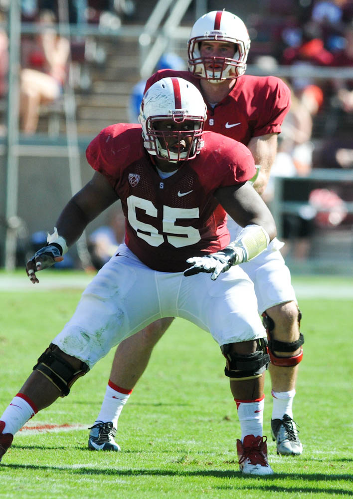 Fifth-year senior center Khalil Wilkes (front) is known as the Cardinal's funniest offensive lineman. He doesn't just relay signals at the line of scrimmage; on the practice field, he has invented his own language. (AVI BAGLA/The Stanford Daily)