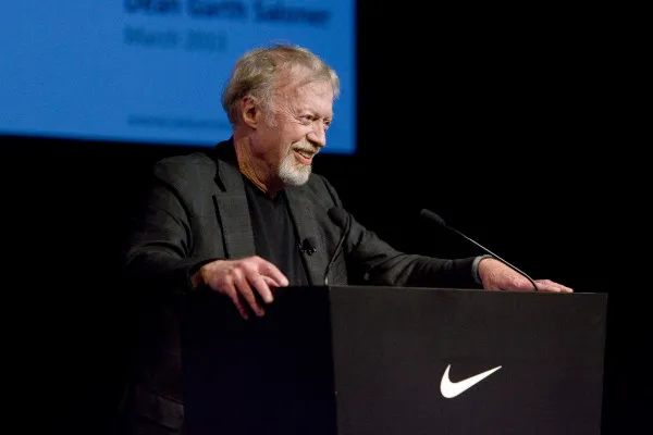 Despite being the major benefactor of Oregon football, Phil Knight M.B.A. '62, pictured above speaking at a GSB event, has maintained his connection to Stanford. (David Rezok)