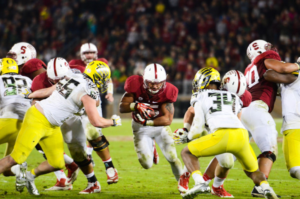 Senior running back Tyler Gaffney (center) carried the ball a school-record 45 time on Thursday night, as the Cardinal running game controlled the tempo against the Ducks all night. Stanford finished with a 274-62 advantage in rushing yards against the nation's second-leading rushing attack. (SIMON WARBY/The Stanford Daily)