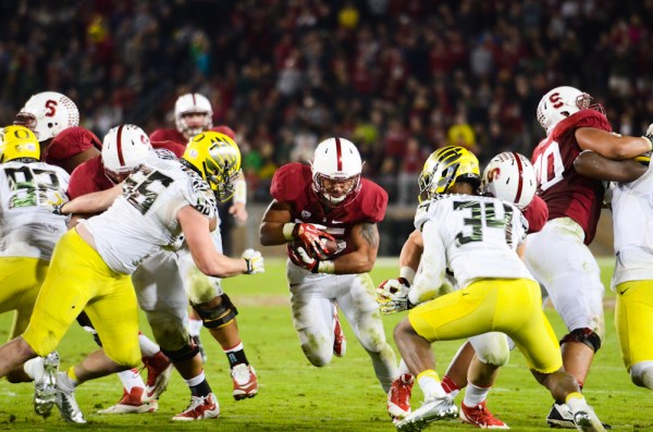 Senior running back Tyler Gaffney (center) carried the ball a school-record 45 time on Thursday night, as the Cardinal running game controlled the tempo against the Ducks all night. Stanford finished with a 274-62 advantage in rushing yards against the nation's second-leading rushing attack. (SIMON WARBY/The Stanford Daily)