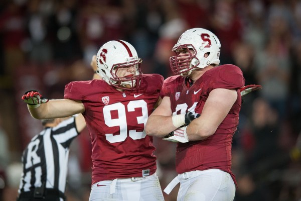 Fifth-year senior outside linebacker Trent Murphy (left) and senior defensive end Henry Anderson (right) look to bring the heat on Irish quarterback Tommy Rees tonight. (Don Feria/isiphotos.com)