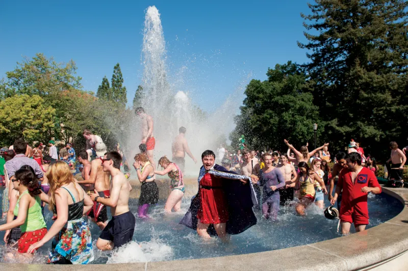 Students and children in front of a Stanford fountain