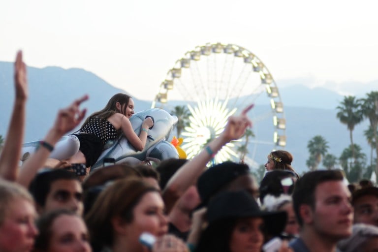 A girl crowd surfs on an inflatable dolphin during MGMT's performance. (SAM GIRVIN/The Stanford Daily)