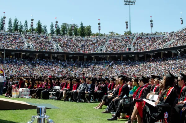 Students sitting in the Stanford Stadium for graduation.