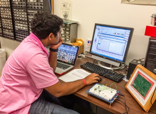 Vikram Prasad '16 works on a lab in EE122A, testing a circuit. (SAM GIRVIN/The Stanford Daily)