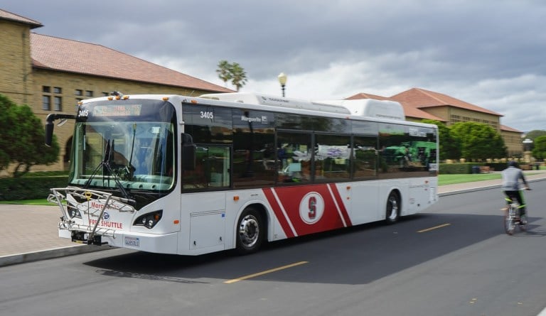 A Marguerite bus drives by Main Quad.