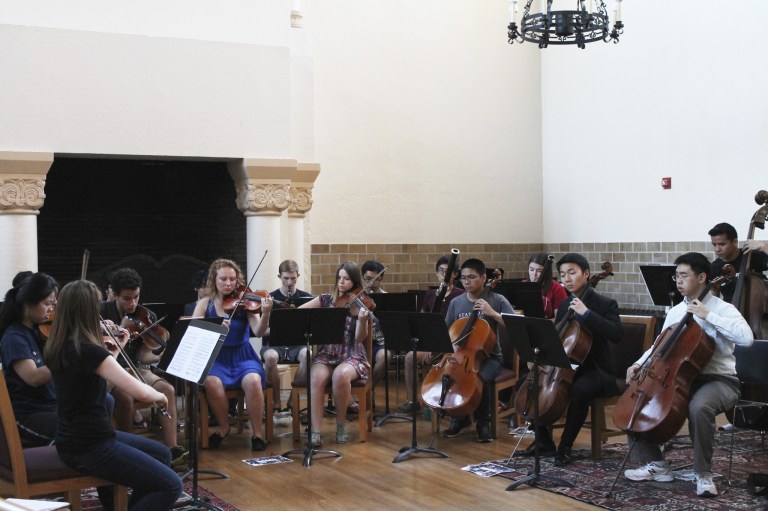 The ensemble acclimates to the acoustics of Toyon Hall in preparation for their upcoming concert. (CATALINA RAMIREZ-SAENZ/The Stanford Daily)