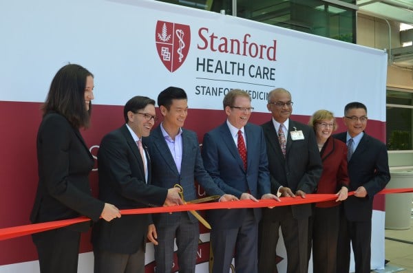 Administrative director Kate Surman MBA ’04, president and CEO of Stanford Health Care Amir Dan Rubin, Assemblymember Evan Low, Dean of Stanford's School of Medicine Lloyd B. Minor, vice president of Cancer and Cardiovascular Service Lines Sridhar Seshadri, director of the Stanford Cancer Institute Beverly Mitchell and Assemblymember Kansen Chu cut the ribbon for Stanford Health Care’s South Bay Cancer Center on June 26. (ALINA ABIDI/The Stanford Daily)
