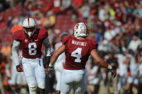 Stanford's defense is going to be gutted in its transition from 2014 to 2015, with fifth-year senior inside linebacker Blake Martinez (right), Kevin Anderson and Ronnie Harris currently slated as the Cardinak's only returning defensive starters. (SAM GIRVIN/The Stanford Daily)