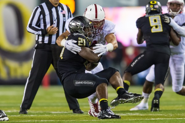 Senior inside linebacker Blake Martinez (rear) wraps up a tackle against Oregon's Royce Freeman (front) in last year's 45-16 drubbing of the Cardinal by the Ducks in Eugene. (JIM SHORIN/stanfordphoto.com)