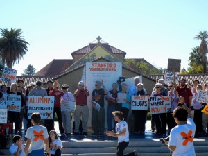 A group of local alumni joined in the sit-in on Thursday and marched to the Alumni Center to say that they will not donate if the University continues to invest in fossil fuels.(McKENZIE LYNCH/The Stanford Daily) 