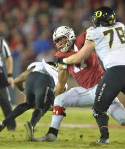 Fifth-year senior defensive end Brennan Scarlett (center) had 2.5 sacks of Oregon quarterback Vernon Adams in one of the best performances of his career. He also forced a fumble with a strip-sack that was returned deep into Oregon territory by Kevin Anderson. (SAM GIRVIN/The Stanford Daily)