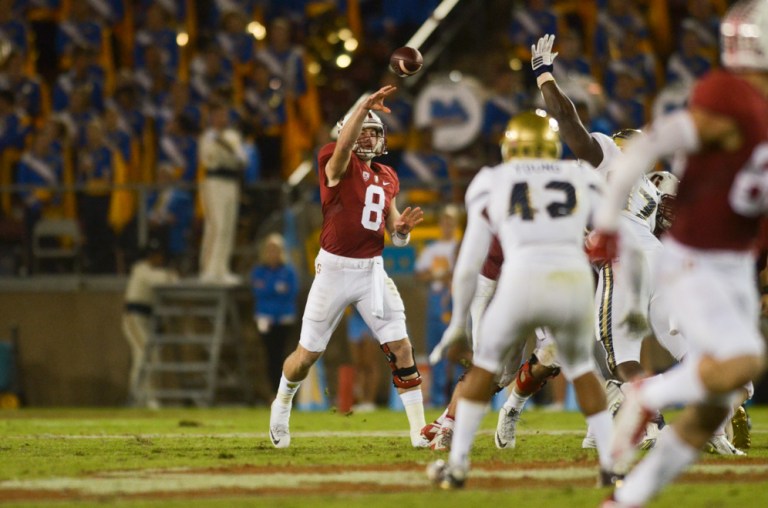 Fifth-year senior quarterback Kevin Hogan (left) led the Cardinal with 112 rushing yards on Saturday night to top Washington State 30-28. Stanford dropped one spot in the AP Poll to No. 9 after the near loss to the Cougars. (SAM GIRVIN/The Stanford Daily)