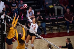 In her Senior Night celebration, outside hitter Brittany Howard (center) notched her 10th double-double of the season with 12 kills and 13 digs. (RAHIM ULLAH/The Stanford Daily)