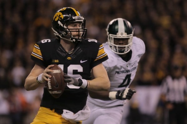 Iowa quarterback C.J. Beathard (left) looks downfield during the Big Ten Championship against Michigan State in Lucas Oil Stadium in Indianapolis on Saturday, Dec. 5, 2015. The Spartans defeated the Hawkeyes in the last seconds of the game, 16-13. (MARGARET KISPERT/The Daily Iowan)
