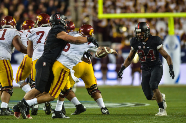 Senior inside linebacker Blake Martinez (left) forces a fumble by USC quarterback Cody Kessler in the third quarter, which was returned 34 yards by Solomon Thomas to give Stanford a two-score lead. The sack was Martinez's first of the year. Martinez led Stanford in tackles with 11. (SAM GIRVIN/The Stanford Daily)