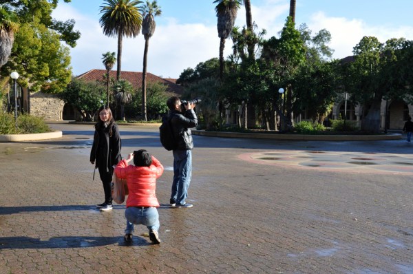 Tourists stop to take photos during their visit on campus. (ALLISON HARMAN/The Stanford Daily)