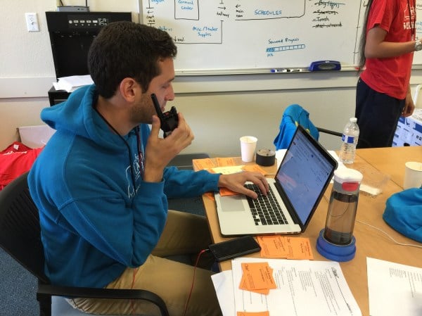 Nick Rodriguez '18 answering a walkie-talkie message in Building 110.