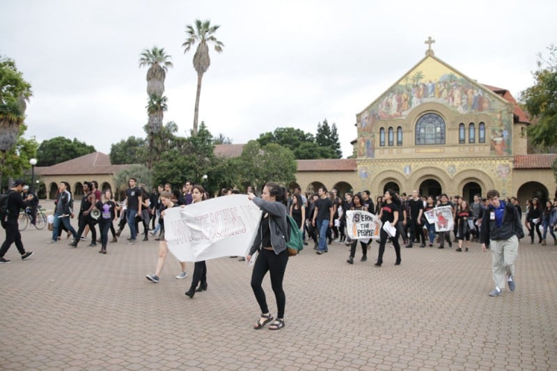 Members of Who's Teaching Us (WTU) march through the Main Quad. One of the group's main demands was to increase faculty diversity (ROBERT SHI/The Stanford Daily).