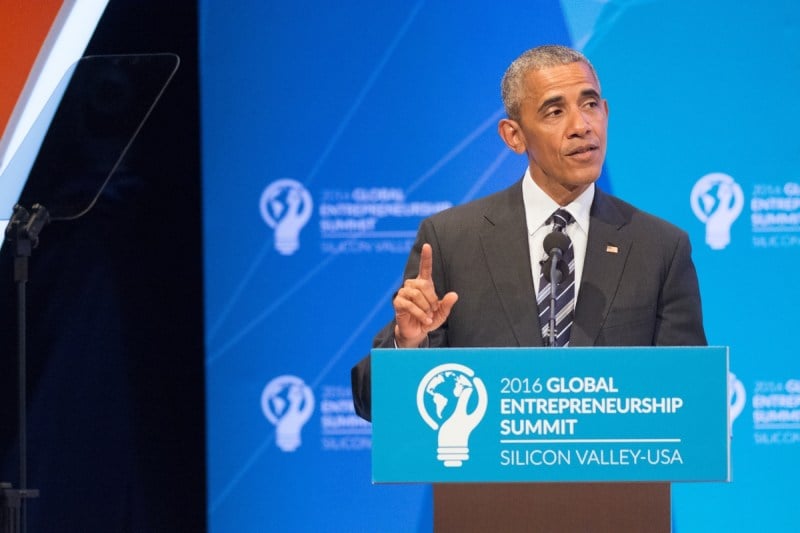 Former President Barack Obama speaking before a podium.