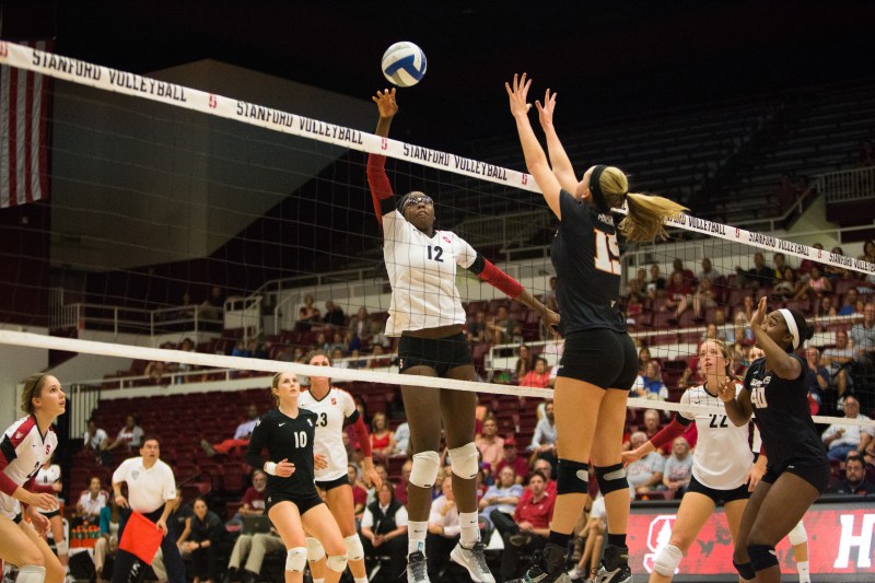 Fifth-year senior middle blocker Inky Ajanaku (left) returned to action in the Cardinal's season opener against University of San Diego. Ajanaku, a three-time All-American is poised to play a key role in Stanford's upcoming season. (ROGER CHEN/The Stanford Daily)