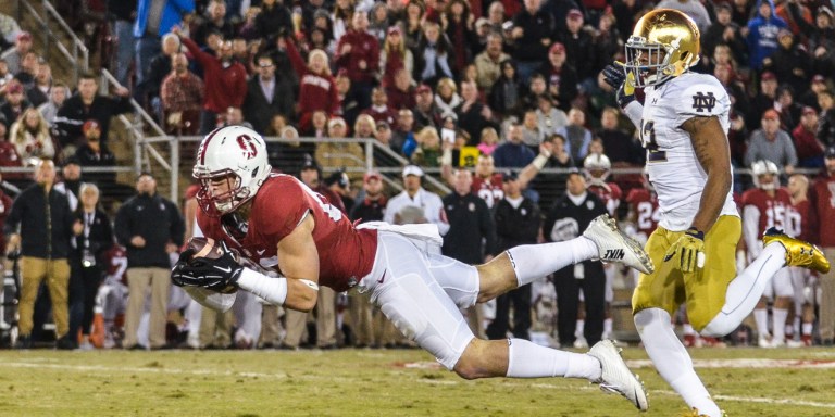 Wide receiver Devon Cajuste makes a diving grab in last year's tilt with Notre Dame, in which he racked up 125 receiving yards to lead the Cardinal. Saturday's game in South Bend could see an improvement in Stanford's currently stagnant offense as senior wide receiver Francis Owusu returns from injury. (SAM GIRVIN/The Stanford Daily)