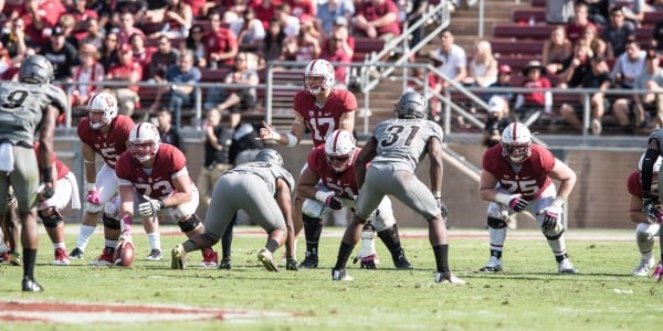 Senior quarterback Ryan Burns (center) takes a snap during Stanford's 10-5 loss to Colorado, in which the Cardinal had an anemic offensive performance. (RYAN JAE/The Stanford Daily)
