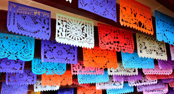 Papel picado hangs from a ceiling. (TIMELEWISNM/Flickr)