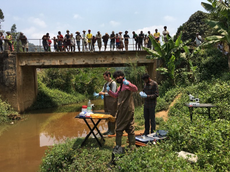 In Madagascar with a local co-worker, Manu Prakash (center) and Deepak Krishnamurthy (right) gather for study the larvae that cause schistosomiasis. (Courtesy of Saad Bhamla)