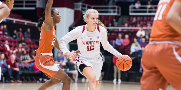 Brittany McPhee brings the ball towards the net, aptly avoiding defenders. The junior guard and her team made a statement with a definitive win against Texas on Monday night. (RAHIM ULLAH/The Stanford Daily)
