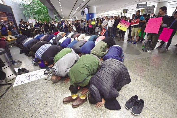 People of the Muslim faith pray near the international arrival gates on Jan. 29 while attending a protest at San Francisco International Airport ( Courtesy of Jose Carlos Fajardo/Bay Area News Group/TNS).
