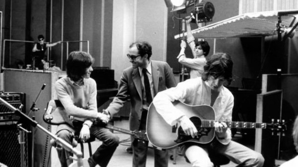 Jean-Luc Godard (center) shakes hands with Keith Richards (l) as Mick Jagger strums his guitar in Godard's "Sympathy for the Devil" (Courtesy of PopOpiq).