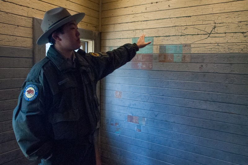 To pass the time, detainees carved messages and poetry into the walls. Here, Park Ranger Daniel Inouye points to a portion that has been restored after being filled in and painted over by officers to discourage the practice which was seen as vandilism. Still, there is a lot we can learn from these messages, from the living conditions to the demographic of those detained.