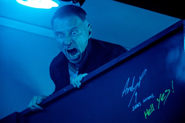 Begbie (Robert Carlyle) raging over toilet cubicle in Danny Boyle's "T2: Trainspotting." (Courtesy of TriStar Pictures)