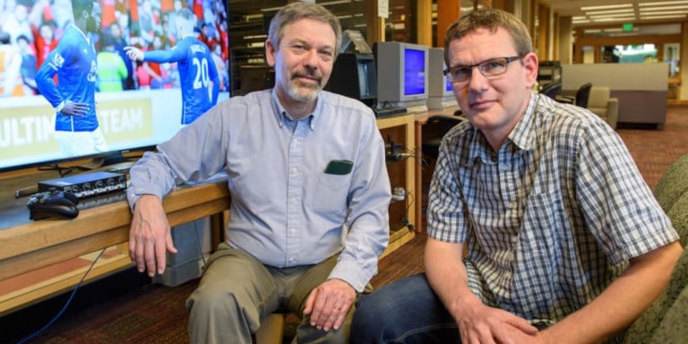 Henry Lowood curator, History of Science & Technology and Film & Media Collections and Ingmar Riedel-Kruse, assistant professor of bioengineering in the media library of Stanford's Green Library.