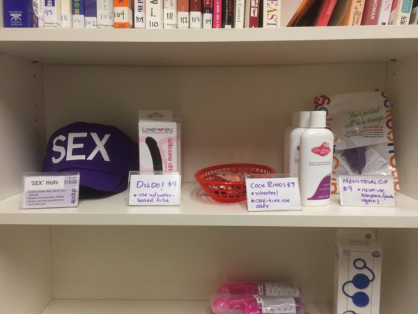 Various sex toys, lubricants, sex books, menstrual products sit on a shelf at SHPRC