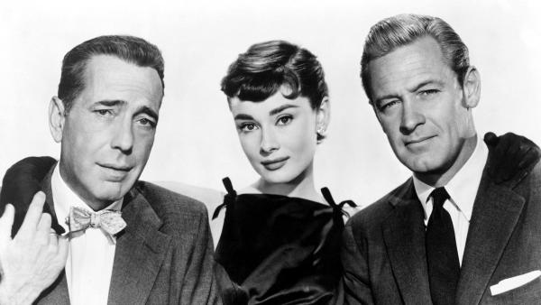 (l-r) Humphrey Bogart, Audrey Hepburn, and William Holden in a promotional still for Billy Wilder's 1954 rom-com "Sabrina," which plays with "Roman Holiday" this weekend at the Stanford. Courtesy of Jerry Murbach.