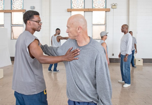Prison Renaissance co-founder Emile DeWeaver in a performance piece with a fellow incarcerated person, Gino Sevacos in a performance piece with Artistic Ensemble San Quentin (Courtesy of Peter Merts).