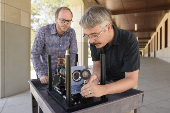 Donald Dansereau handles a prototype of the light-field camera that will allow robots to have clearer vision (Courtesy of Stanford News).