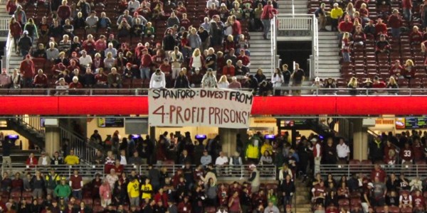 At Saturday's homecoming football game, student activists unfurled a banner urging Stanford's divestment from companies associated with private prisons (Courtesy of Michael Ocon).