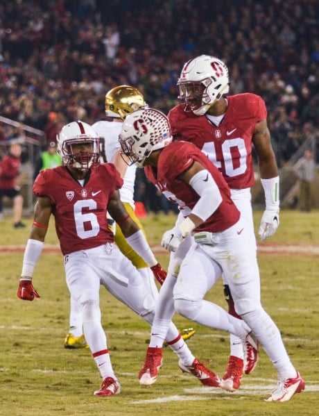 Stanford alumni Taijuan Thomas (6), and current seniors Brandon Simmons (2) and Bobby Okereke (40) celebrate a successful kickoff coverage last season verus Washington. Special teams and defense will be huge for the Cardinal this year in a difficult game against a No. 9 ranked Washington team. (SAM GIRVIN/The Stanford Daily)