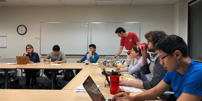 The 2018 Graduate Student Councilors sitting at a table