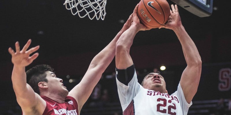 Reid Travis manages to attack the basket despite a tough defense. Travis is one of the veteran stars that help lead the Cardinal.
 (RYAN JAE/The Stanford Daily)