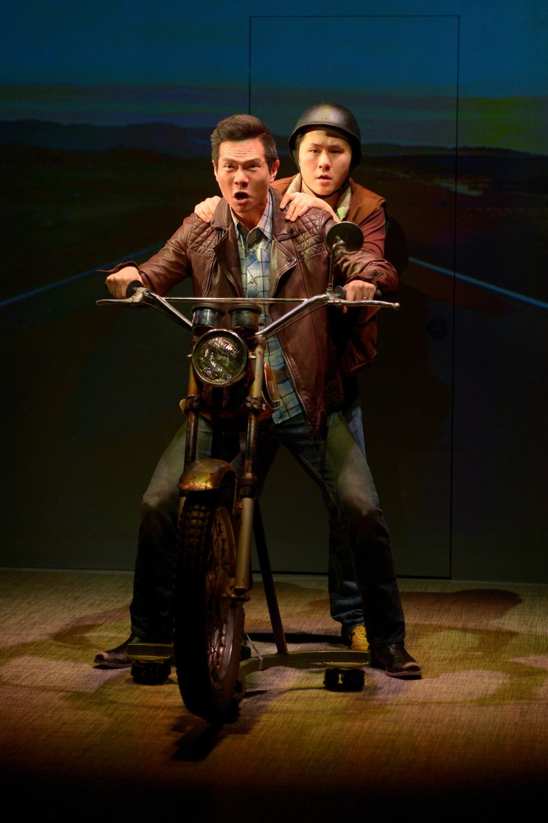 Quang (James Seol, front) and friend Nhan (Stephen Hu, back) embark on a motorcycle trip from Arkansas to California in Qui Nguyen’s Vietgone. (Courtesy of Kevin Berne)
